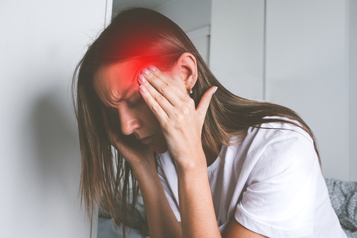Woman experiencing a cervicogenic headache