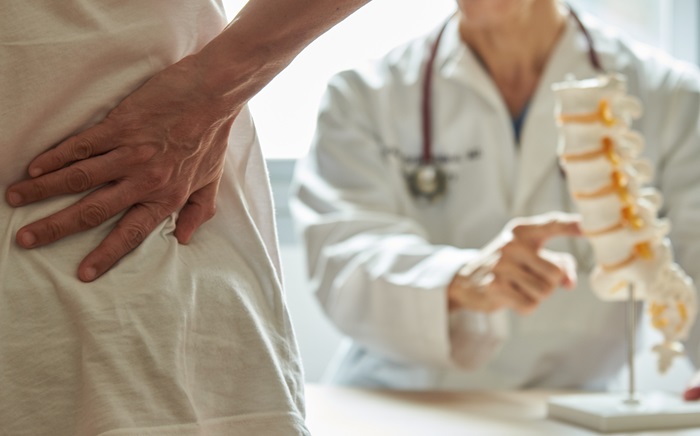 Spine doctor explaining spinal stenosis to a patient