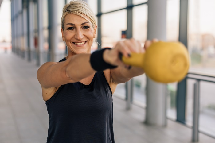 Woman working out with a kettle bell.