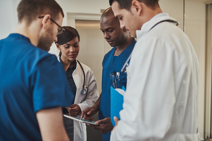Orthopedic and pain management doctors discussion a patient