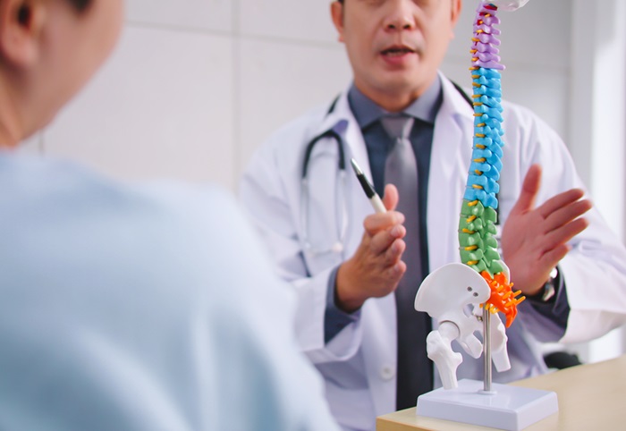 Orthopedic surgeon explaining a spinal condition to a patient