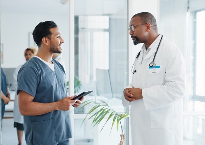 Doctor and chiropractor discussing medical treatment