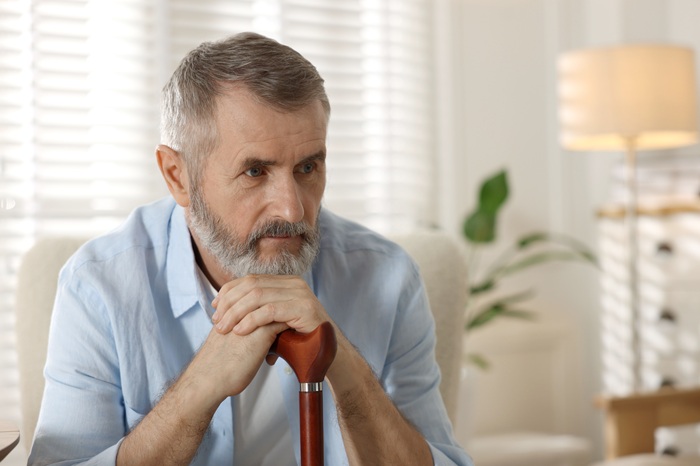 Middle aged man with a cane