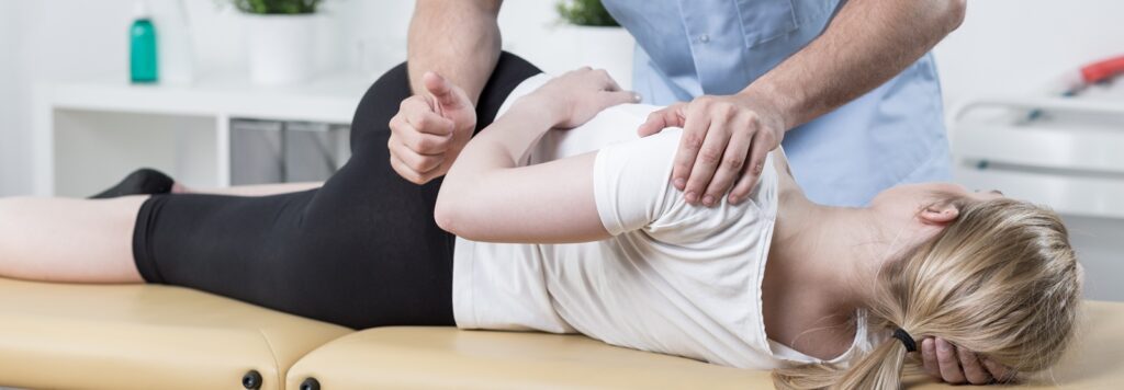 Chiropractor adjusting patient