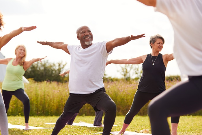 Middle age man in outdoor yoga class