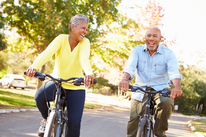 Married middle age couple riding bicycles