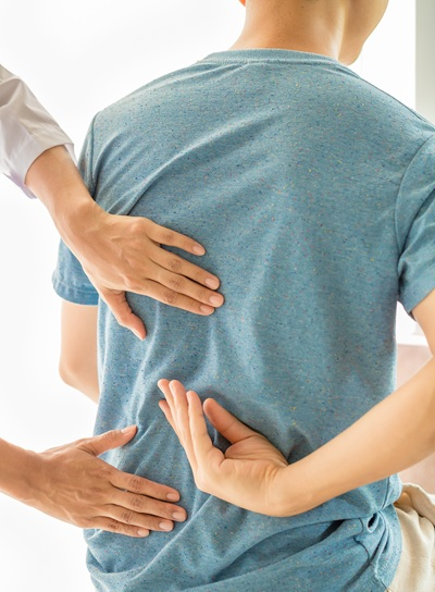 Physical therapist assessing a thoracic spine condition