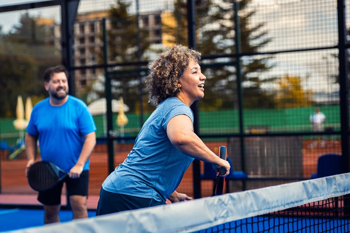 Husband and wife playing pickleball