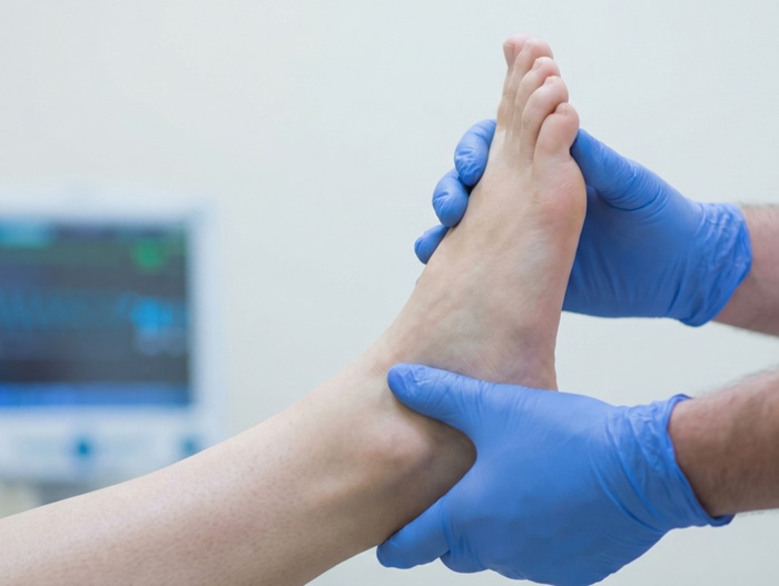 Provider assessing the cause of ankle pain