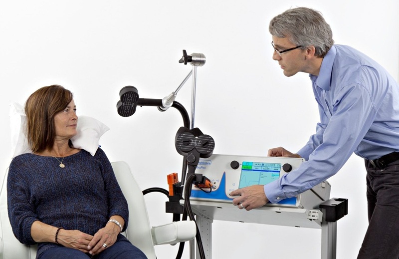TMS clinician explaining the treatment to a patient
