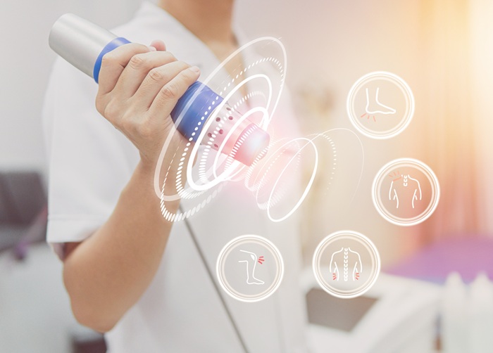 Provider holding a shockwave therapy device