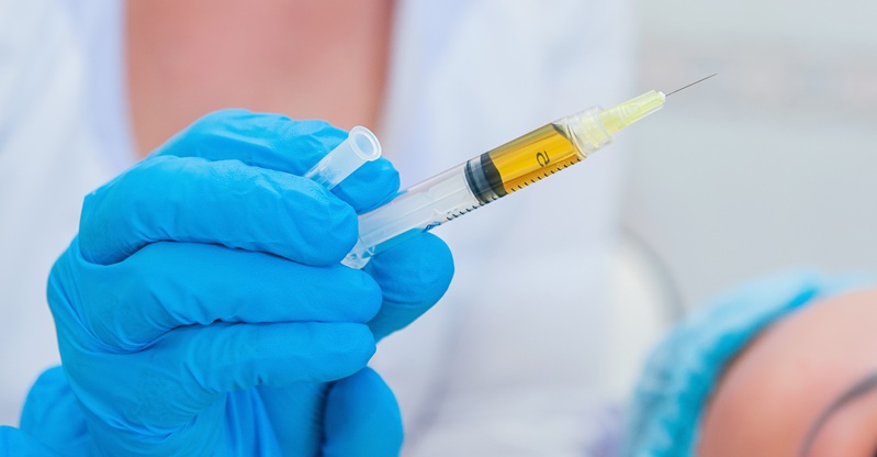 Physician holding a syringe
